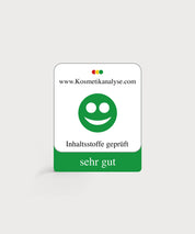 Kosmetikanalyse-Siegel von kosmetikanalyse.com mit grünem Smiley, Text „Inhaltsstoffe geprüft“ und Bewertung „sehr gut“.
